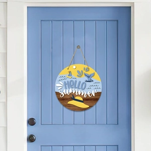 Detail of Hello Summer wooden door sign with ocean theme hanging on a light blue door