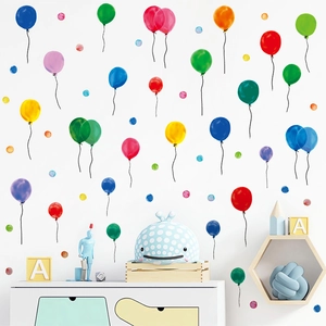 Detail of colorful watercolor balloon wall stickers and polka dots in a nursery setting
