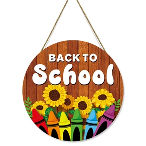 Round wooden Back to School welcome sign with colorful crayons and yellow sunflowers