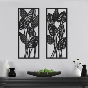 Set of 2 black leaf wall art with geometric patterns on a grey wall backdrop