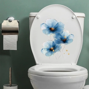 Detail of blue daisy flower stickers with gold veins applied to a white toilet lid