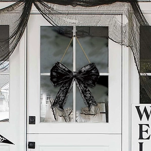 Gothic Halloween welcome sign with black bow and lace print hanging on a white door