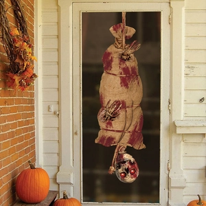 Hanging Halloween decoration with bloody burlap body and glowing red skull head for party