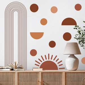Detail view of boho geometric sun and arch wall decals in a warm living room setup