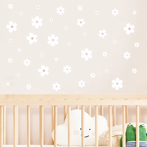 White daisy wall decals in various sizes for boho nursery decor on beige walls