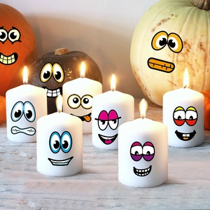 Set of 7 Halloween DIY cartoon pumpkin face stickers on white pillar candles