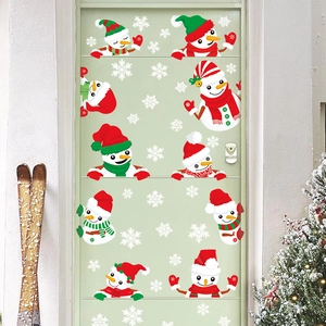 Christmas window stickers featuring cartoon snowmen and white snowflakes on a green door