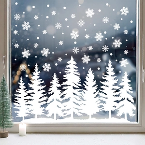 Festive white Christmas window stickers featuring snowflakes and snowy pine forest trees