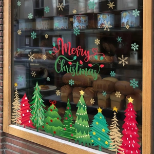 Merry Christmas window stickers featuring colorful trees and snowflakes on a glass storefront