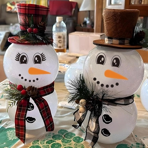 Light-up snowman tabletop figurines with plaid hats, pine cones and warm glowing lights