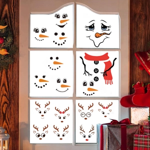 Detail of Christmas snowman and reindeer window stickers on a six-pane glass frame