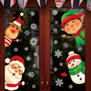 Christmas window stickers featuring Santa, snowman, and reindeer on a glass door