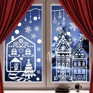 White Christmas window stickers featuring gingerbread houses and snowflakes on glass