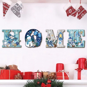 Close-up of wooden HOME letters featuring snowmen, owls and winter patterns