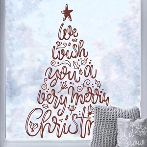 Christmas tree shaped vinyl wall sticker with merry Christmas lettering on a snowy window