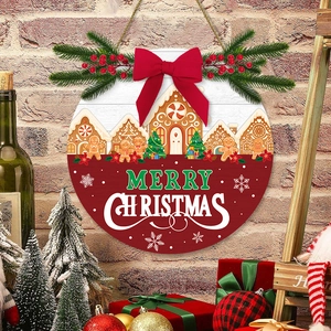 Round wooden Merry Christmas door sign with gingerbread house and red bow on brick wall