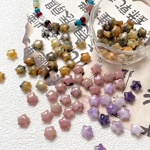 Star-shaped natural stone beads in assorted colors with a religious beaded necklace