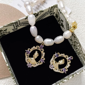 Vintage Victorian jewelry set with baroque pearls and purple gemstones in a gift box