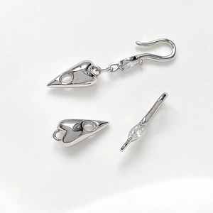 Macro detail of silver heart-shaped toggle clasp with cubic zirconia for DIY jewelry