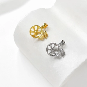 Detailed close-up of hollow wheel rabbit pendants in gold and silver for DIY jewelry