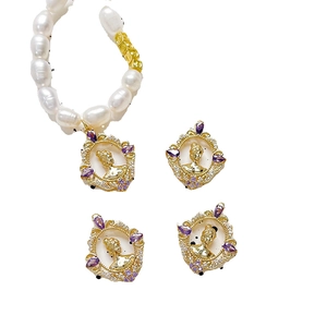 Baroque pearl necklace and earrings set with gold relief pendant and purple gemstones