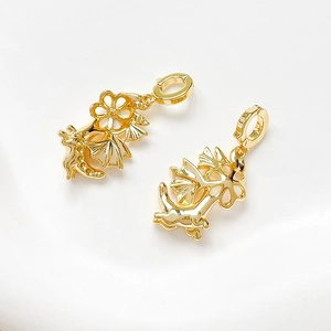 Detailed view of two gold-plated dragon wing charms for DIY jewelry making and crafts