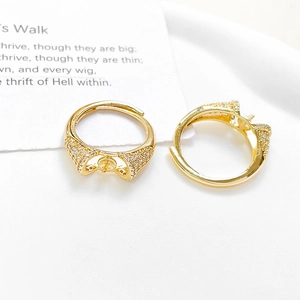 Detailed view of adjustable gold plated ring settings with micro-set zircon and pearl pin