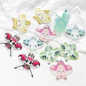 Detailed flat lay of colorful acrylic kite charms in traditional Chinese folk art styles