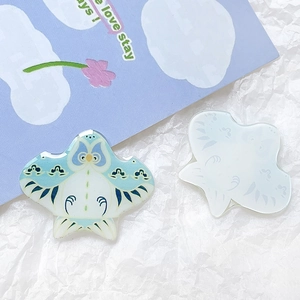 Detail of blue acrylic bird pendant with vintage patterns for DIY hair accessories