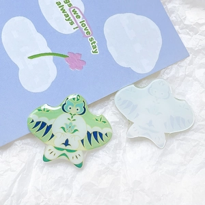 Macro detail of acrylic kite charms with colorful resin finish and translucent texture