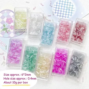 Top view of 10 candy colors 6mm glass bugle beads in plastic boxes for DIY jewelry making