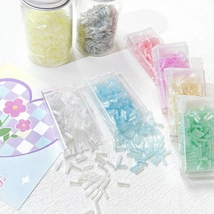 Detailed view of colorful 6mm glass bugle beads with iridescent finish for DIY crafts