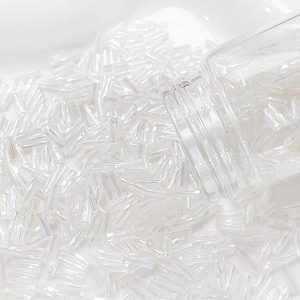 Macro shot of 6mm cream white bugle beads with AB finish for DIY jewelry crafting