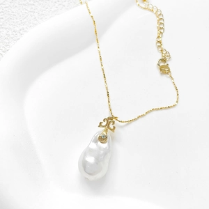 Baroque pearl pendant necklace with gold chain and cutout double T metal connector