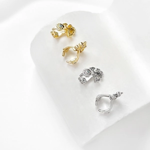 Close-up of vintage hollowed gold and silver connectors with light blue rhinestones
