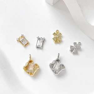 Macro detail of 14k gold and silver plated pendants with cubic zirconia for DIY jewelry