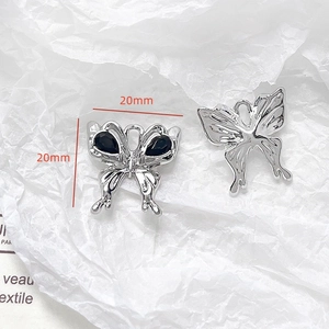 Detail of 20mm silver butterfly charm with black stones and top loop for DIY jewelry