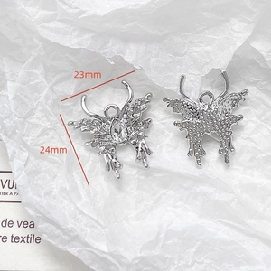Detailed view of butterfly pendant with water drop stone and silver finish charms