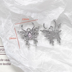 Detailed view of silver butterfly pendant with purple drop stone and crystal accents