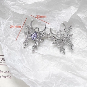 Detailed view of silver butterfly pendant with purple gemstone measuring 24mm by 23mm