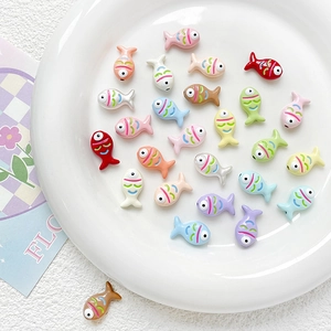 Close-up of colorful hand-painted fish-shaped resin beads for DIY jewelry making