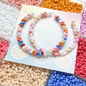 Vibrant multi-color peanut beads on large hoop earrings with a DIY handmade candy aesthetic