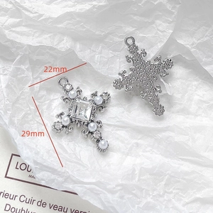Macro view of silver cross pendant with square gem and pearls, size 22mm by 29mm