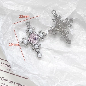 Detail of silver cross pendant with pink gemstone and pearls for DIY jewelry making