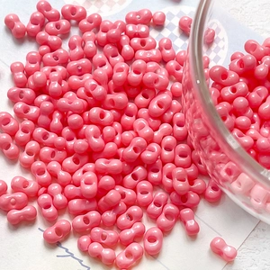 Macro detail of bright pink dual-hole peanut beads for DIY jewelry and crafts making