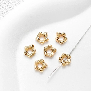 Macro shot of 18k gold plated irregular flower spacer beads for DIY jewelry making