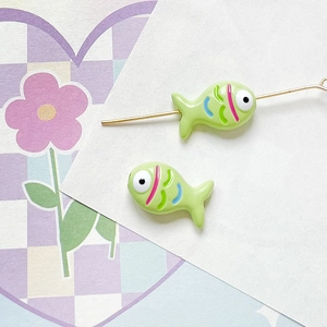Detail of mint green fish beads on wire for DIY jewelry and handmade necklace making