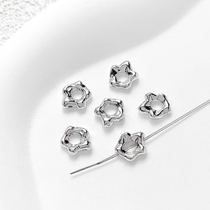 Macro detail of silver star-shaped spacer beads for DIY jewelry making and handmade crafts