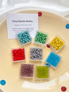 Macro shot of 4mm colorful frosted glass beads in clear storage boxes for jewelry making