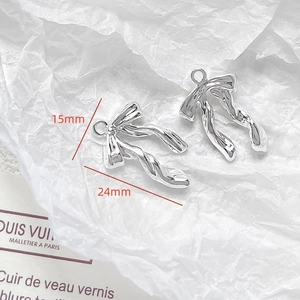 Silver bow pendants for DIY jewelry making with polished metal finish and hanging loops